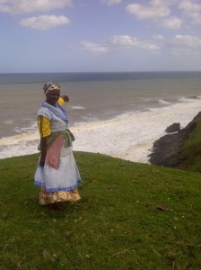 Ma Mtunasi (nee Belem) points out the location where the NS de Belem is believed to have sunk. The rusted metal rod that acts as a landmark is next to her feet.